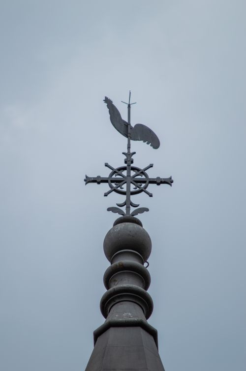 Free A detailed view of a weather vane atop a spire under a cloudy sky in Minas Gerais, Brazil. Stock Photo