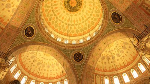 Free View of the ornate dome ceiling of an Ottoman mosque, showcasing Islamic art and architecture. Stock Photo