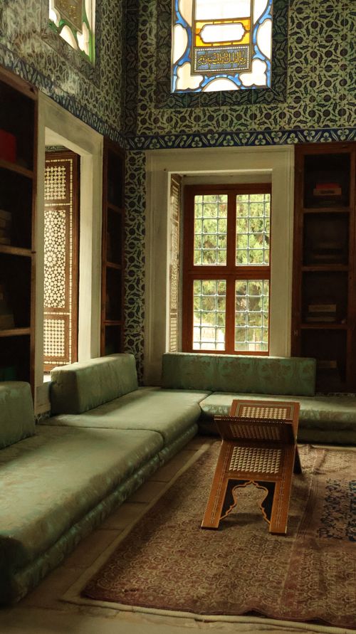 Free Cozy Ottoman-style room with intricate tile work and wooden furniture. Stock Photo