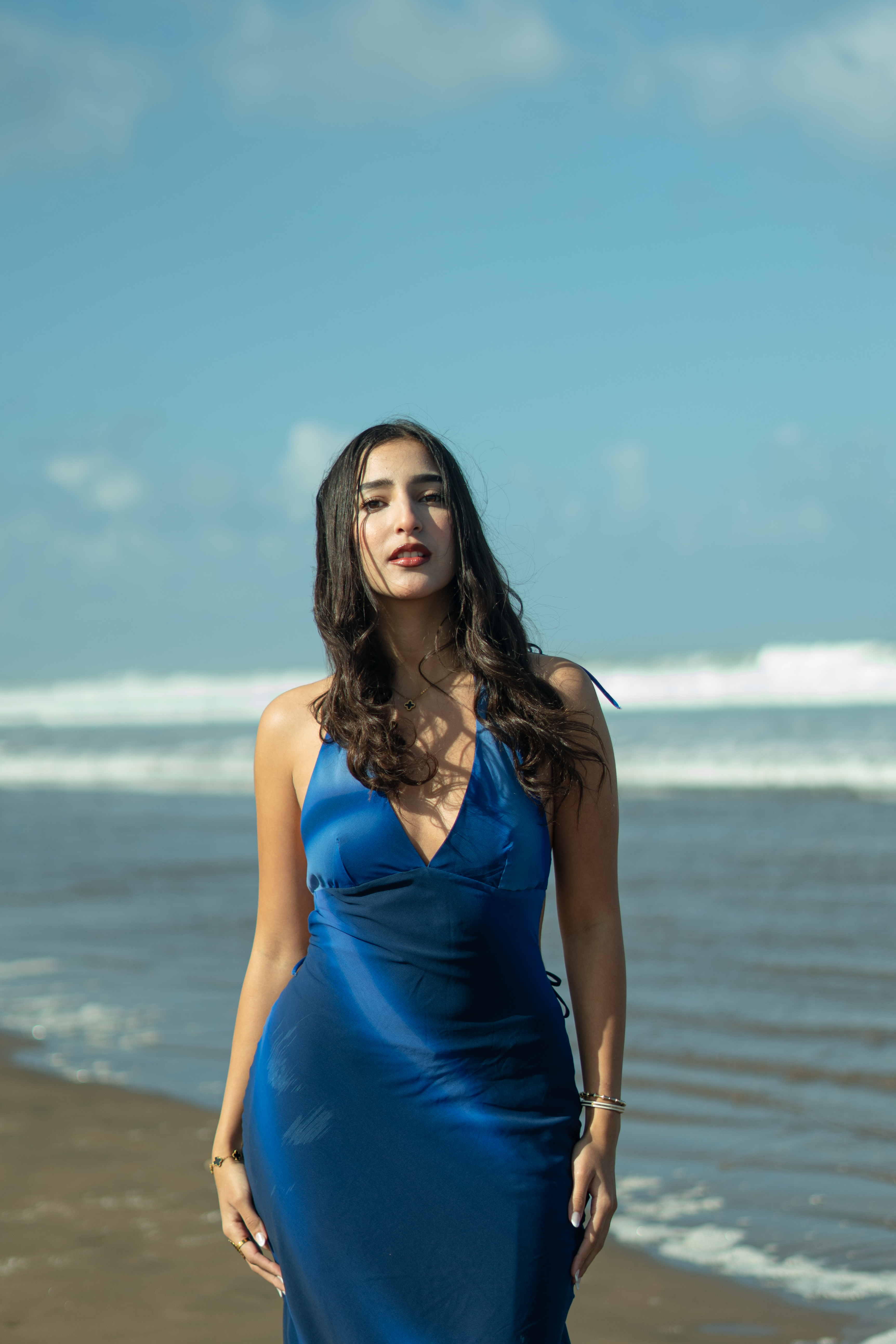 Elegant woman in blue dress on Moroccan beach · Free Stock Photo