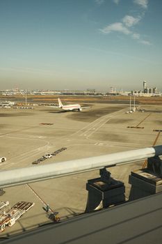 Wide view of an airport runway with aircraft preparing for takeoff under clear skies.