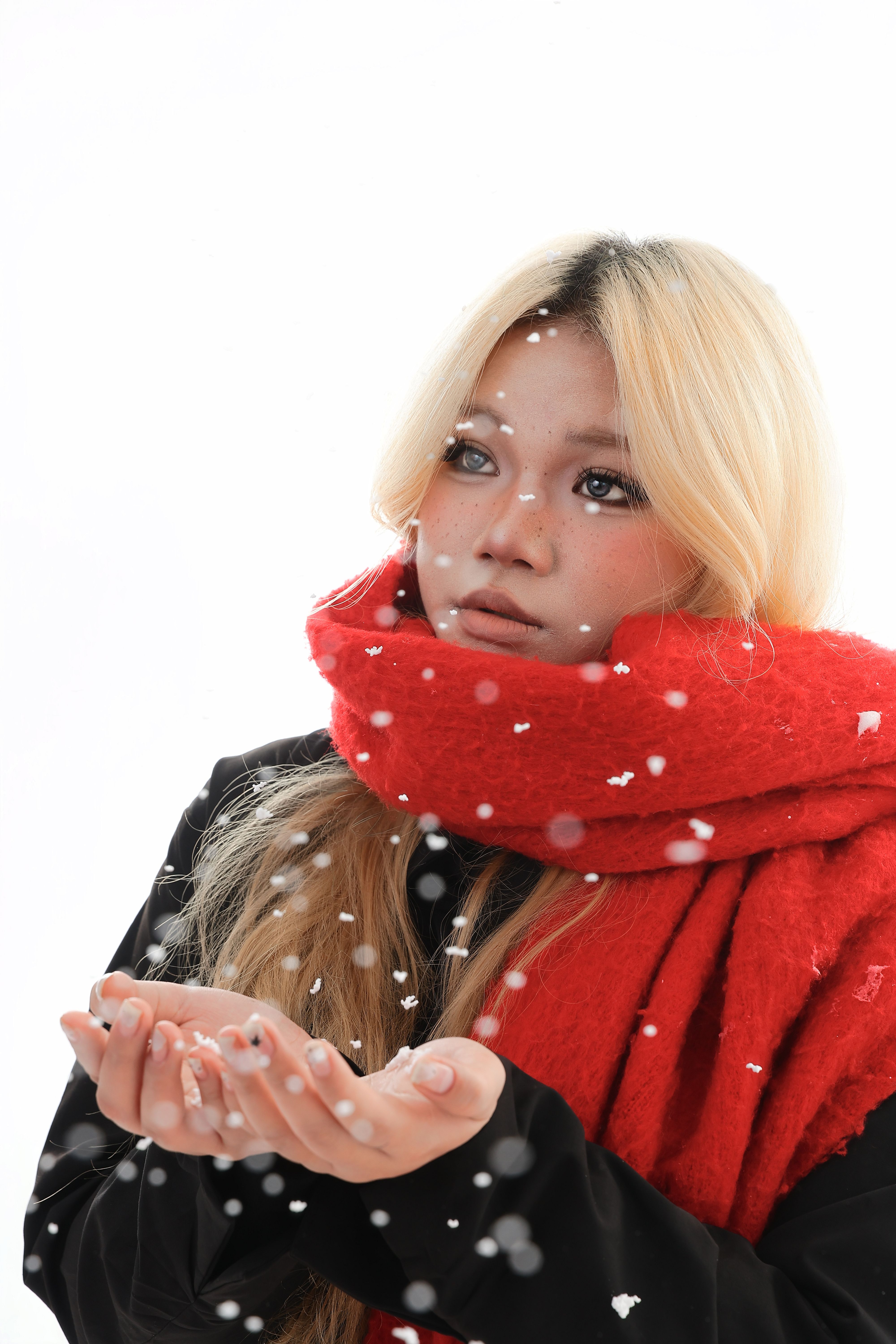 Young woman in red scarf catching snow indoors · Free Stock Photo