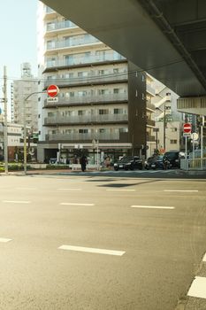 City street corner with high-rise apartments and do not enter signs, a mix of modern architecture and urban lifestyle.