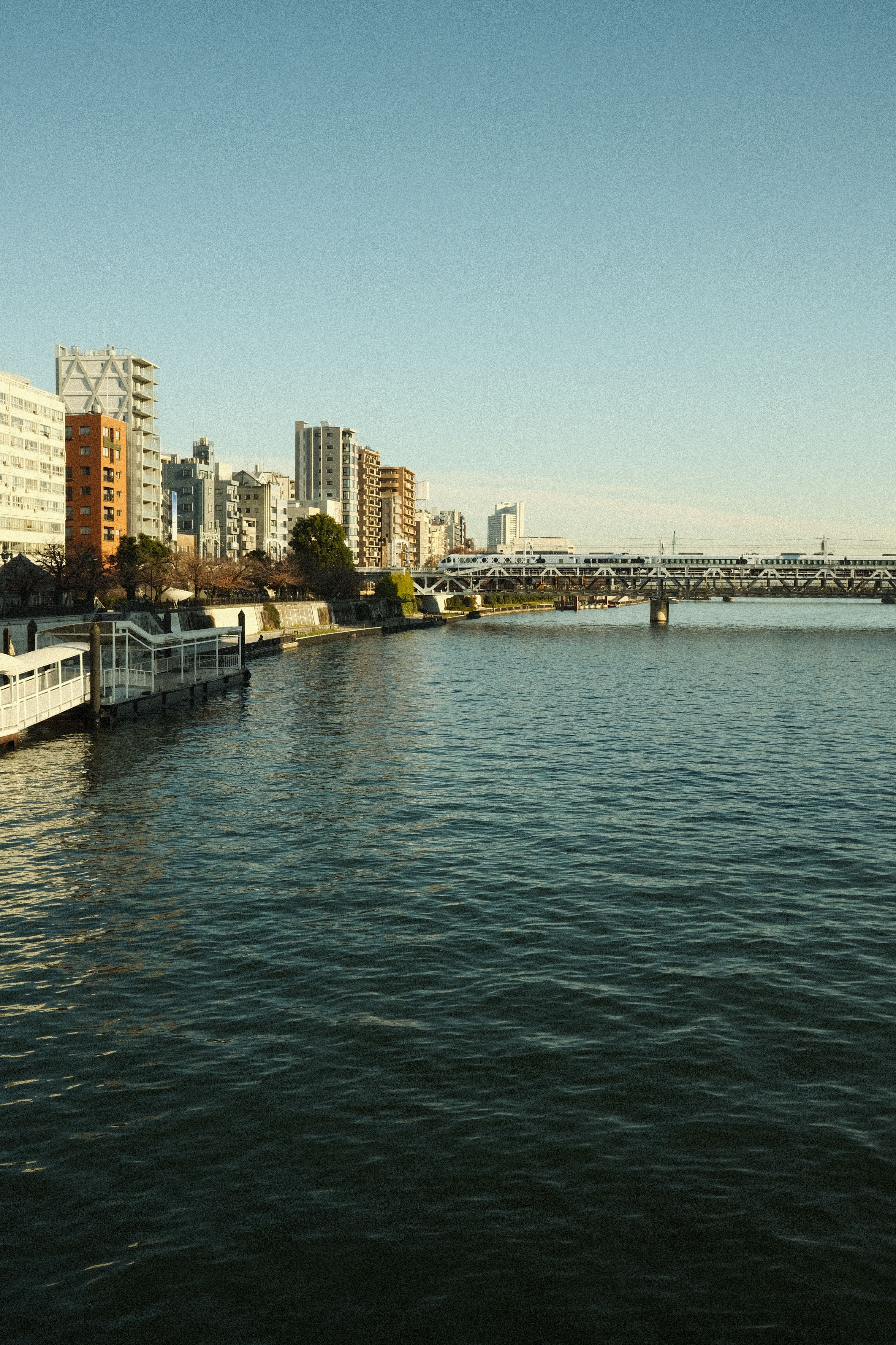 Urban Riverside Scene with Modern Architecture · Free Stock Photo