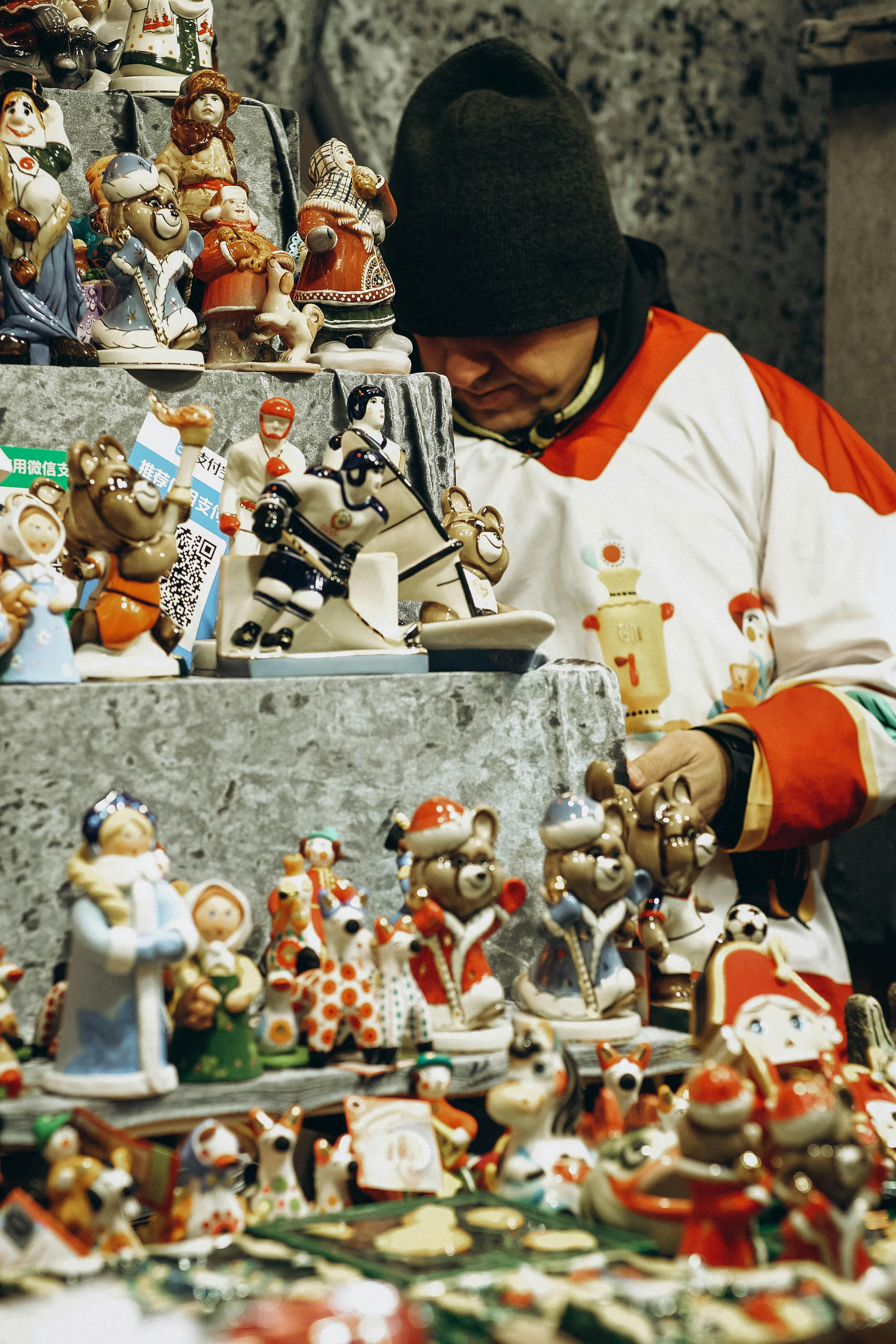 Colorful Christmas market stall featuring holiday figurines and toys, evoking a festive winter atmosphere.
