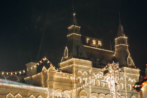 Free A beautifully lit historical building adorned with festive lights during a nighttime celebration. Stock Photo