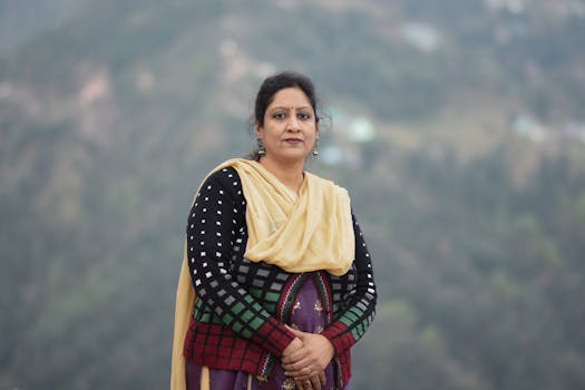 A woman in traditional Indian attire poses outdoors in Dharamshala, Himachal Pradesh, India.