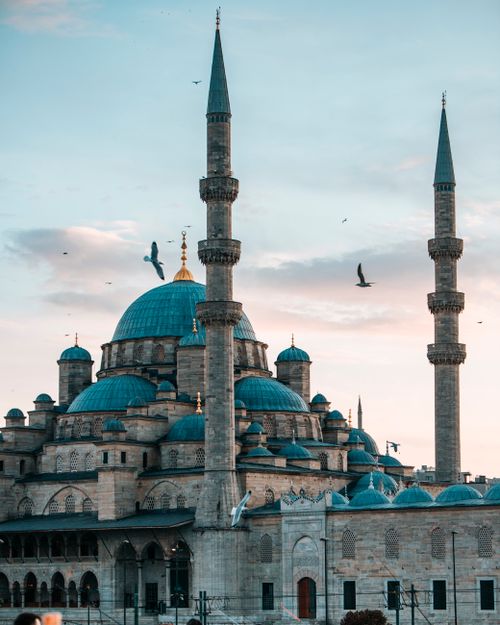 Free The stunning architecture of Istanbul's Blue Mosque against a vibrant evening sky. Stock Photo