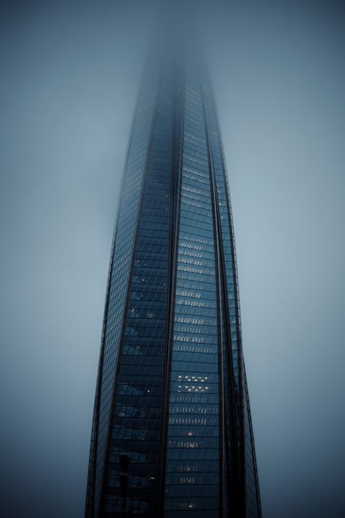 Free A towering skyscraper disappearing into the fog, creating a mysterious and atmospheric scene. Stock Photo