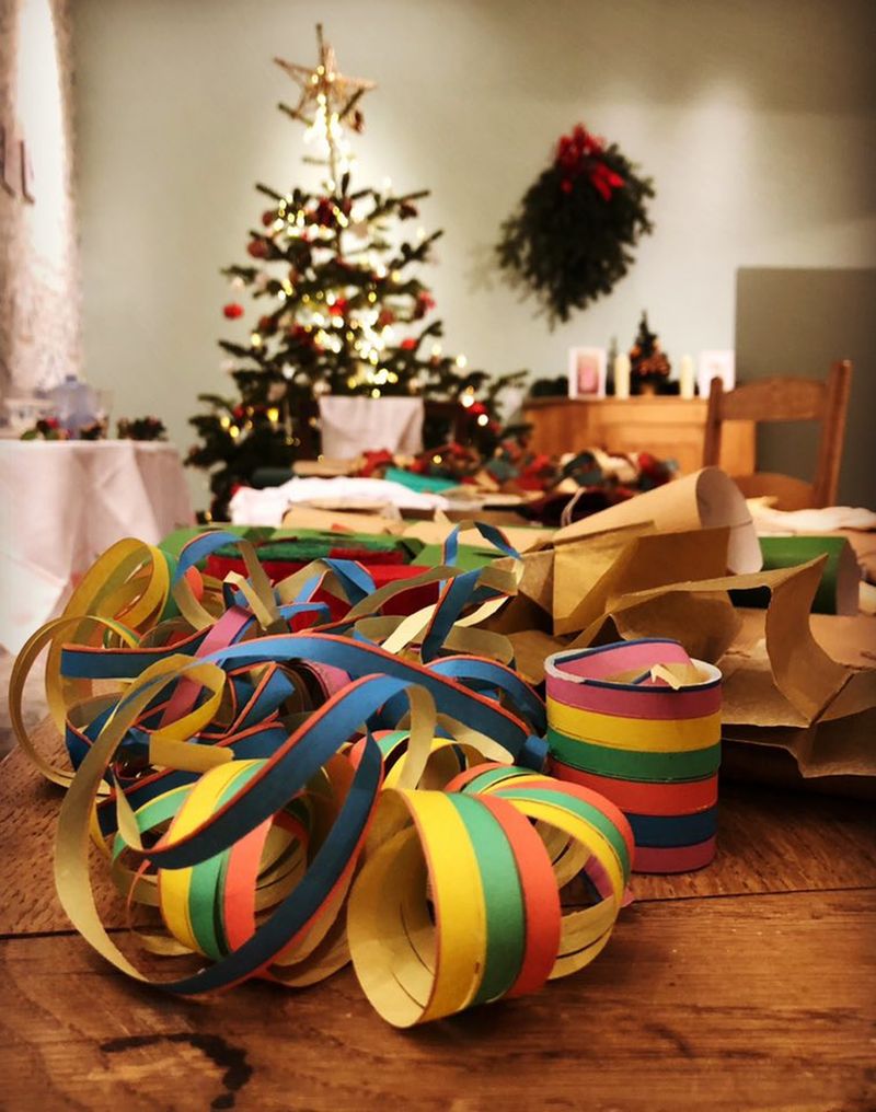 Festive Christmas table with colorful streamers and party decorations