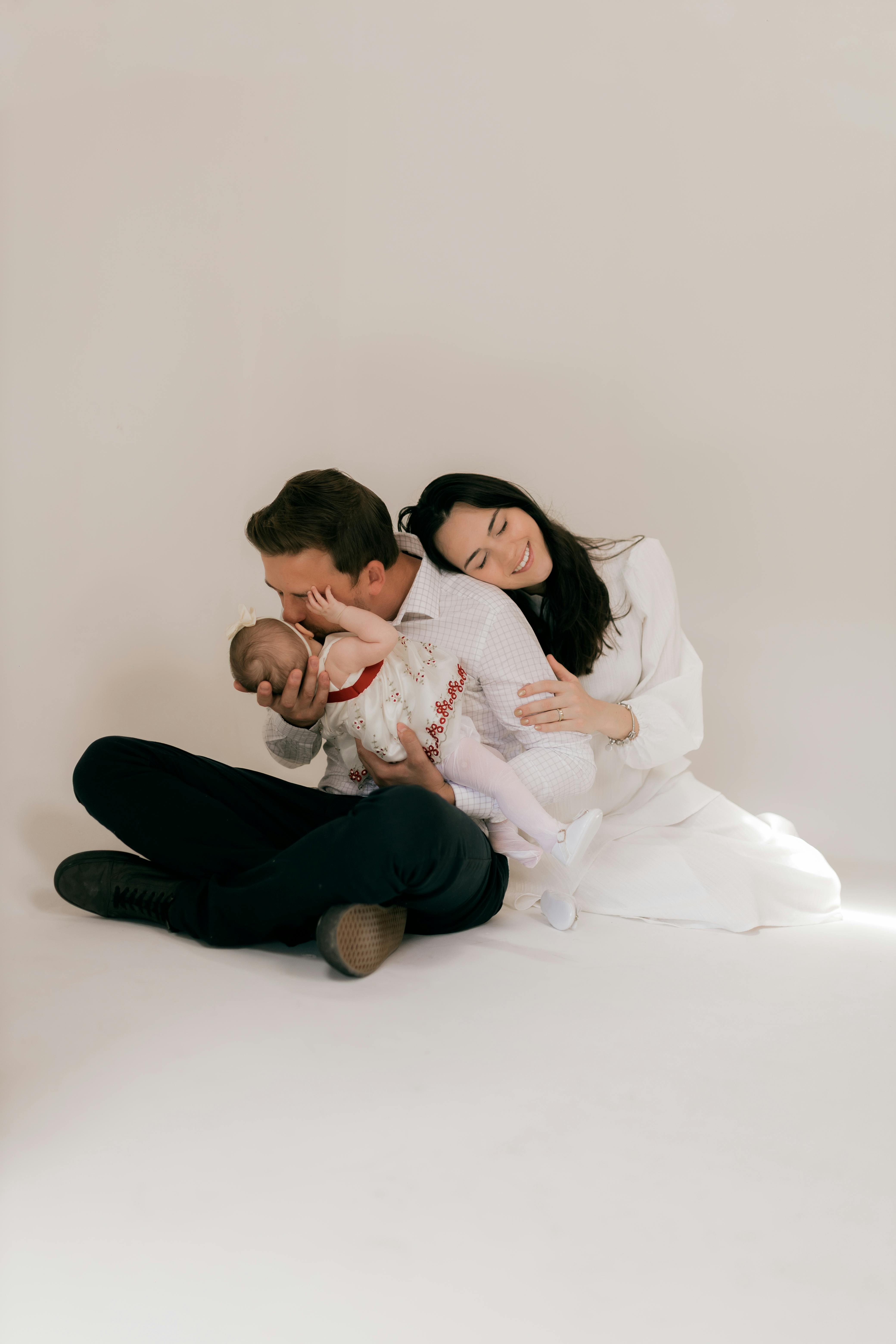 A loving family embracing their newborn baby in a cozy setting.