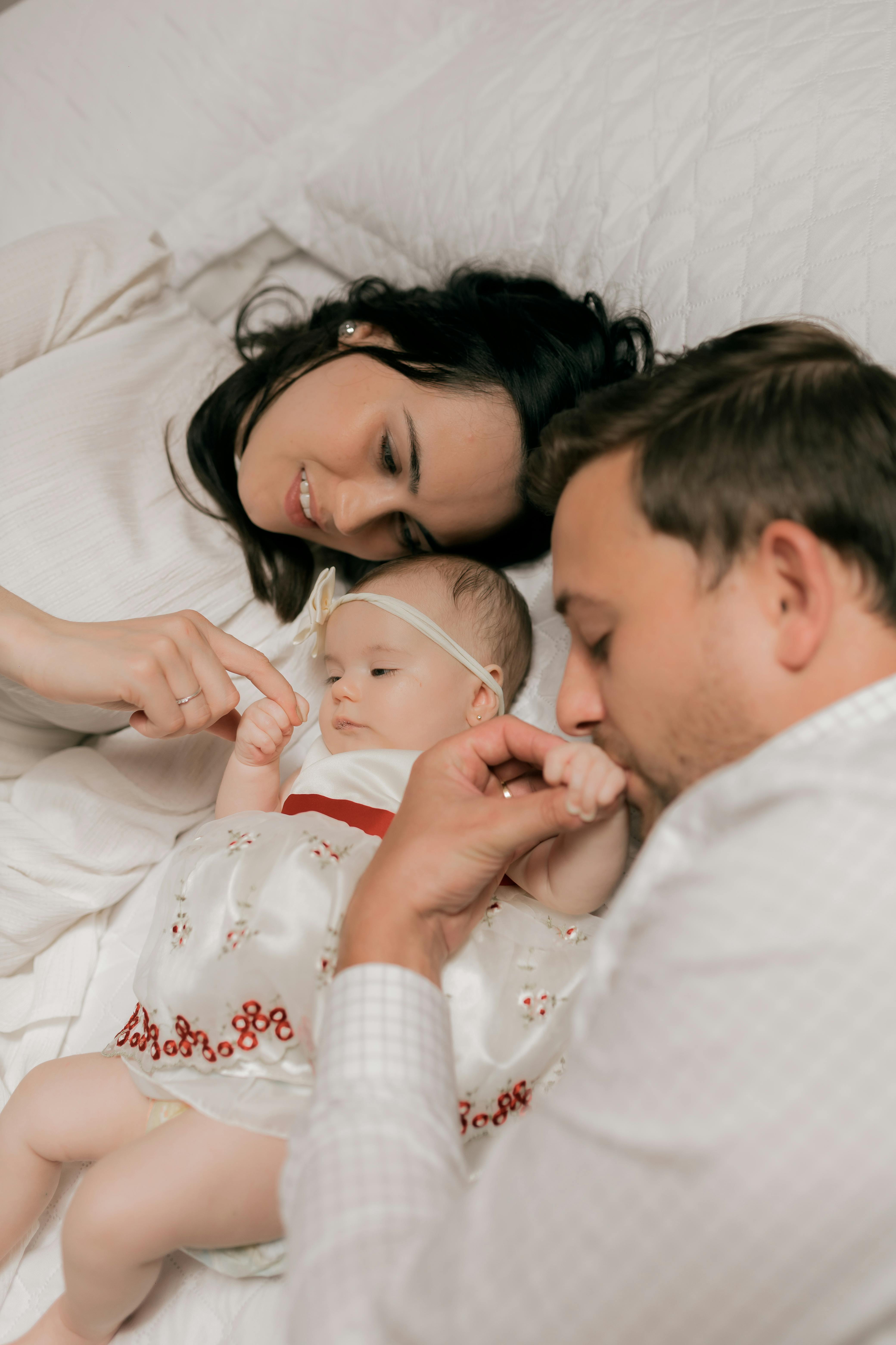 A loving family bonding with their newborn baby, sharing tender moments in soft lighting.