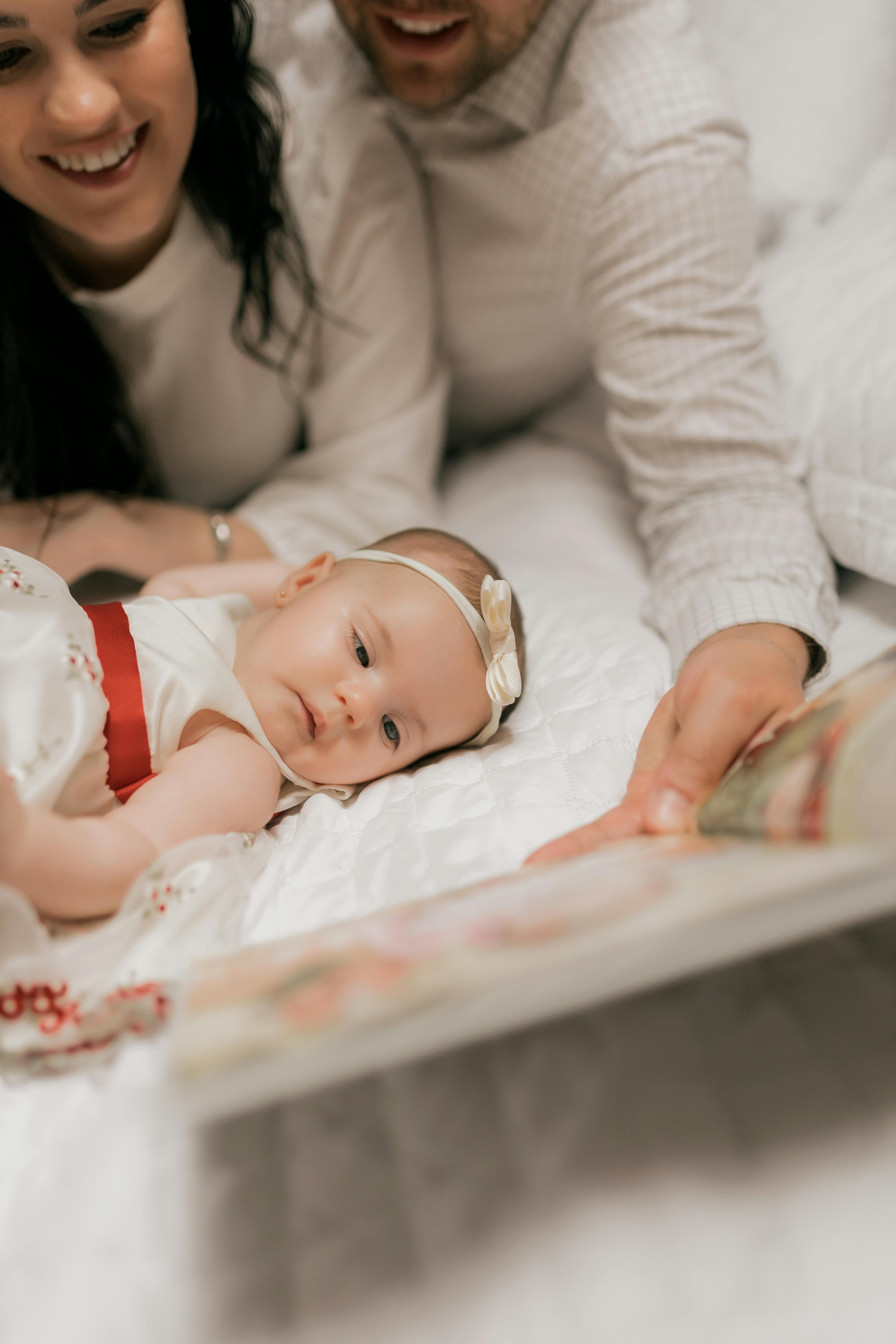 A joyful family reading together with their baby, fostering early learning and bonding.