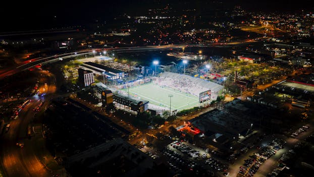 Aerial view of a lit-up football stadium during nighttime in Chattanooga, Tennessee.