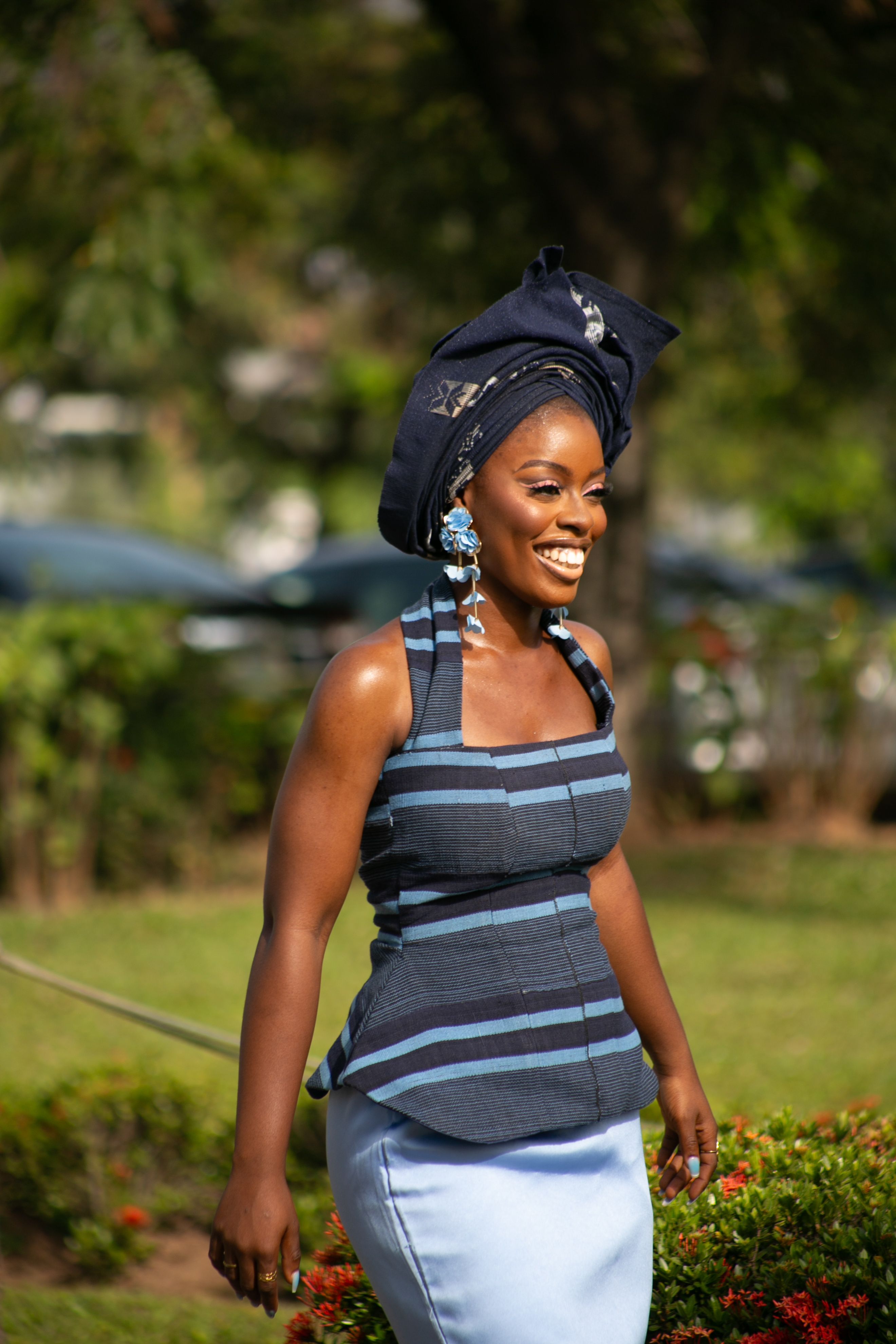 Smiling Woman in Traditional Blue Attire Outdoors · Free Stock Photo