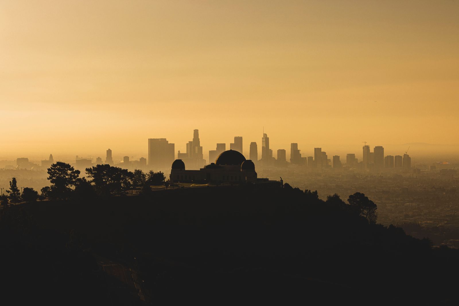 Los Angeles skyline at sunset with Griffith Observatory silhouetted in the foreground