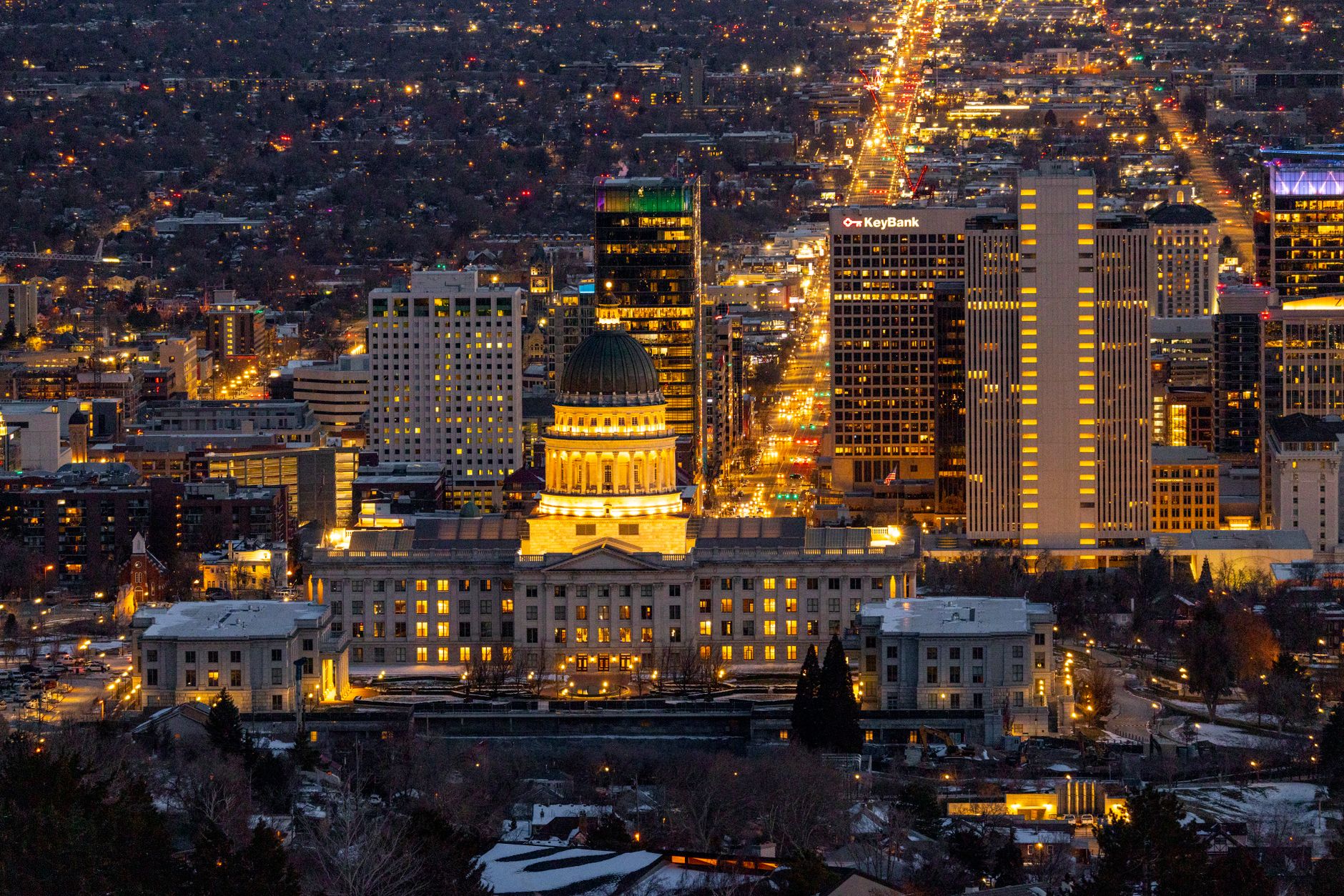 Stunning aerial view of Salt Lake City skyline featuring the Utah State Capitol illuminated at night.