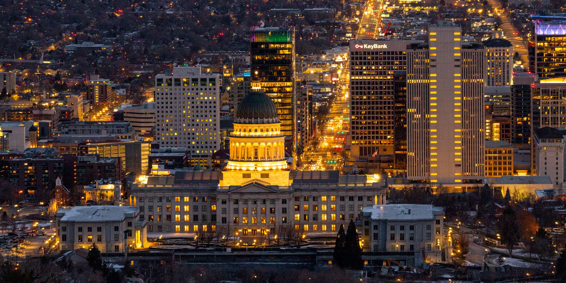 Stunning aerial view of Salt Lake City skyline featuring the Utah State Capitol illuminated at night.