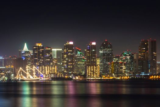 Stunning view of San Diego's illuminated skyline reflecting on the water at night.