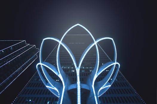 Stunning illuminated skyscraper with futuristic design glowing against night sky.