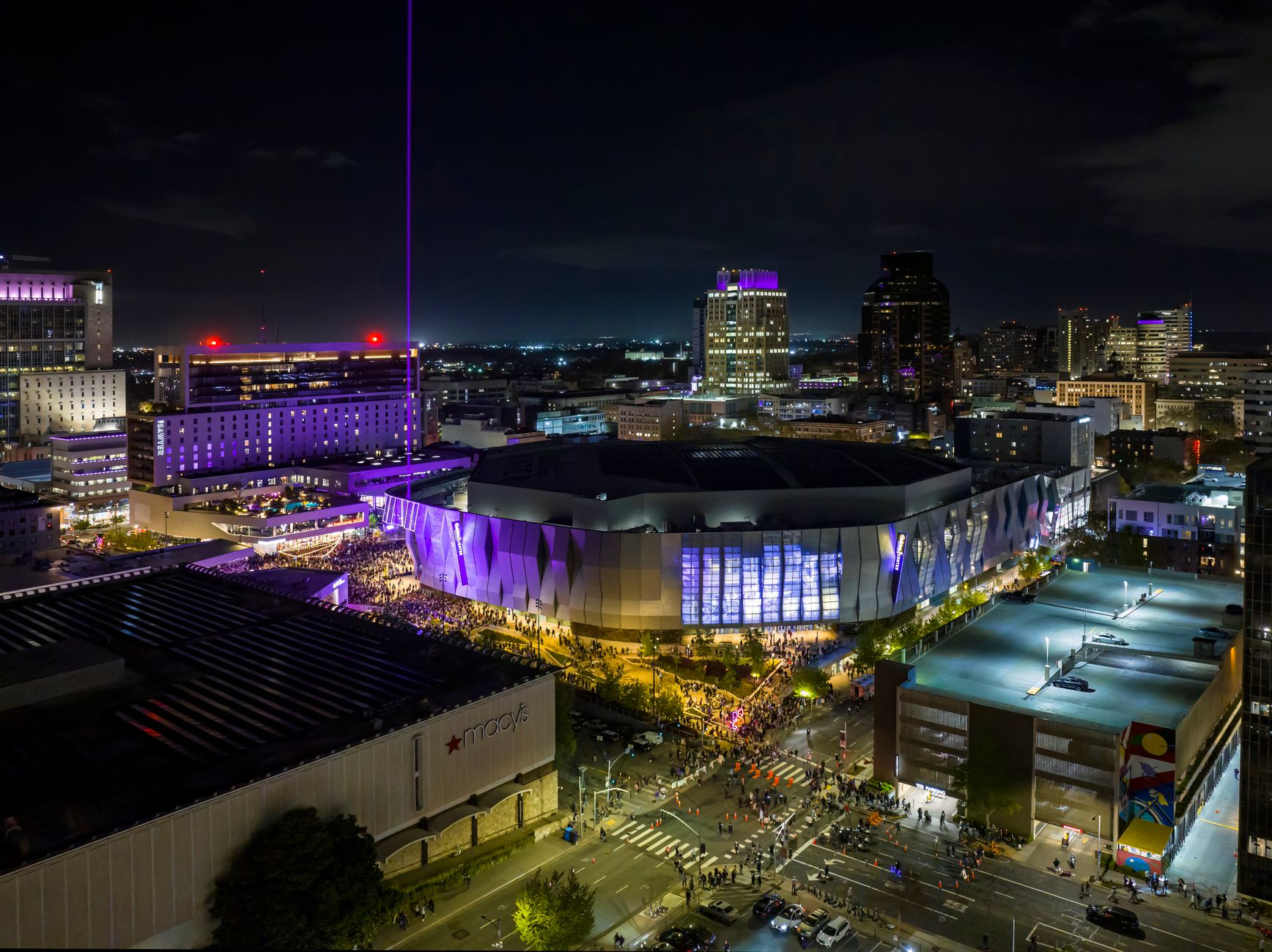Stunning nighttime aerial view of Golden 1 Center in Sacramento, showcasing vibrant city lights.
