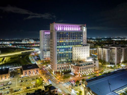 Free Aerial nighttime view of Sacramento's illuminated skyline with city buildings and streets. Stock Photo