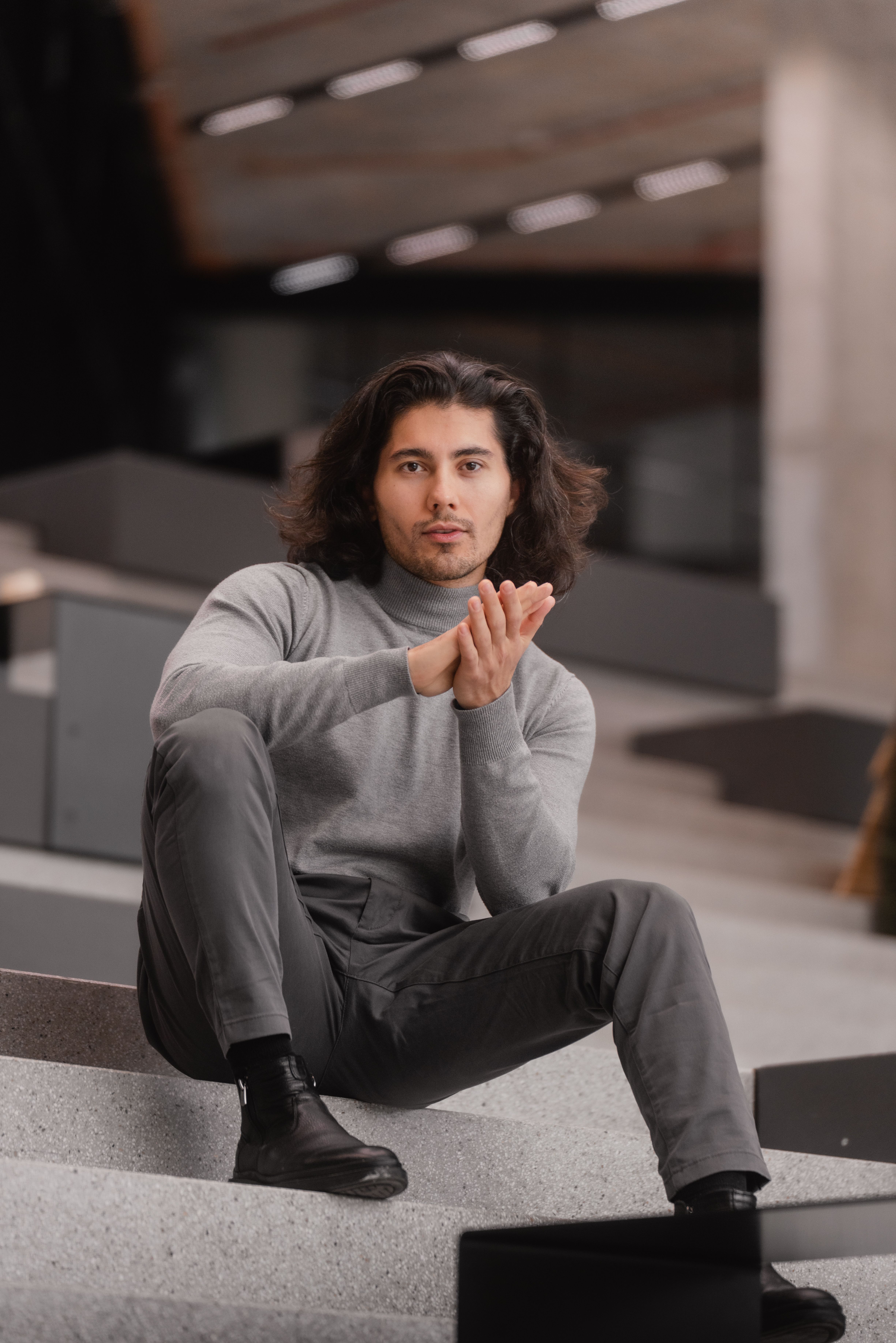 Stylish Young Man Posing in Modern Urban Setting · Free Stock Photo