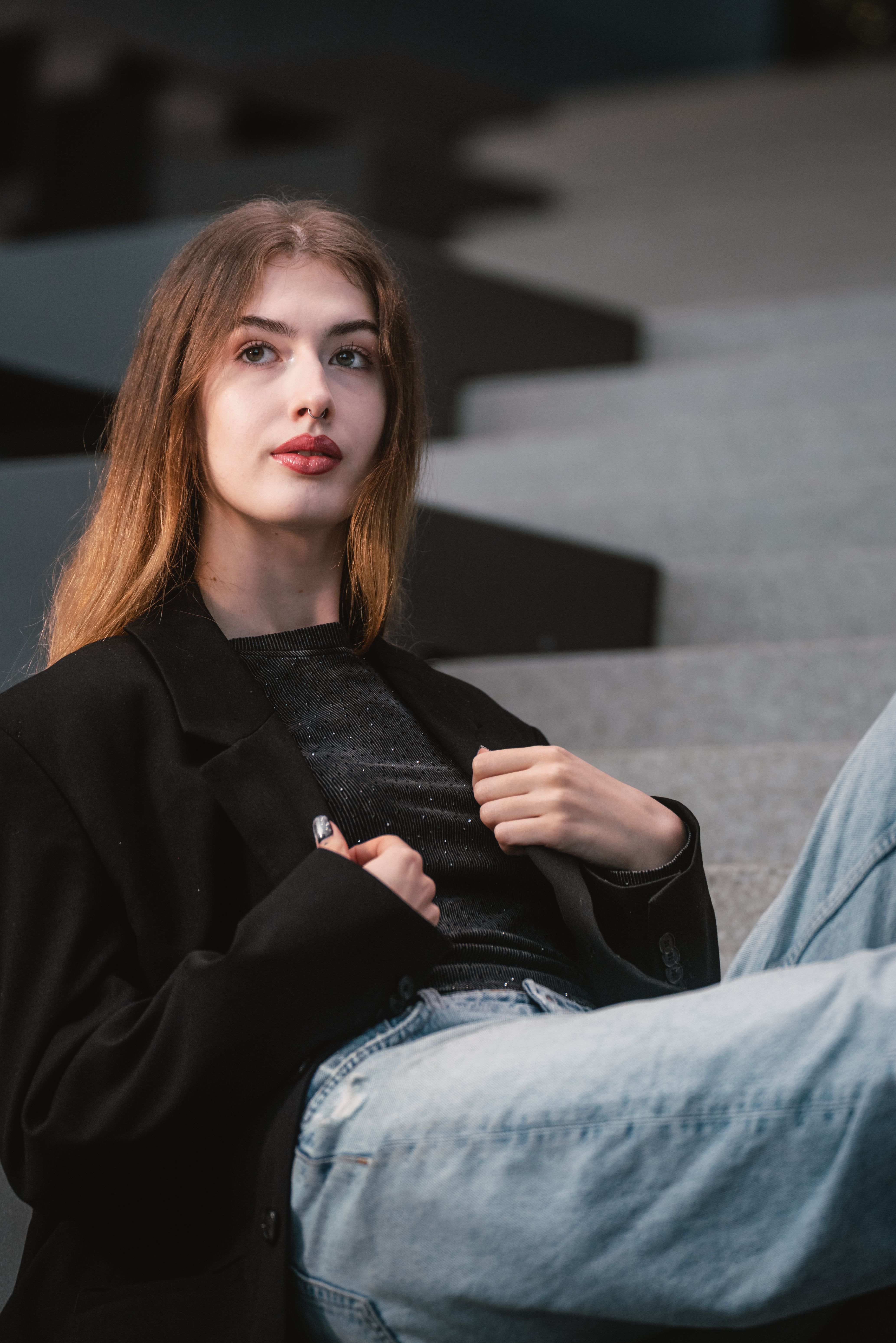 Woman in black blazer with dark jeans