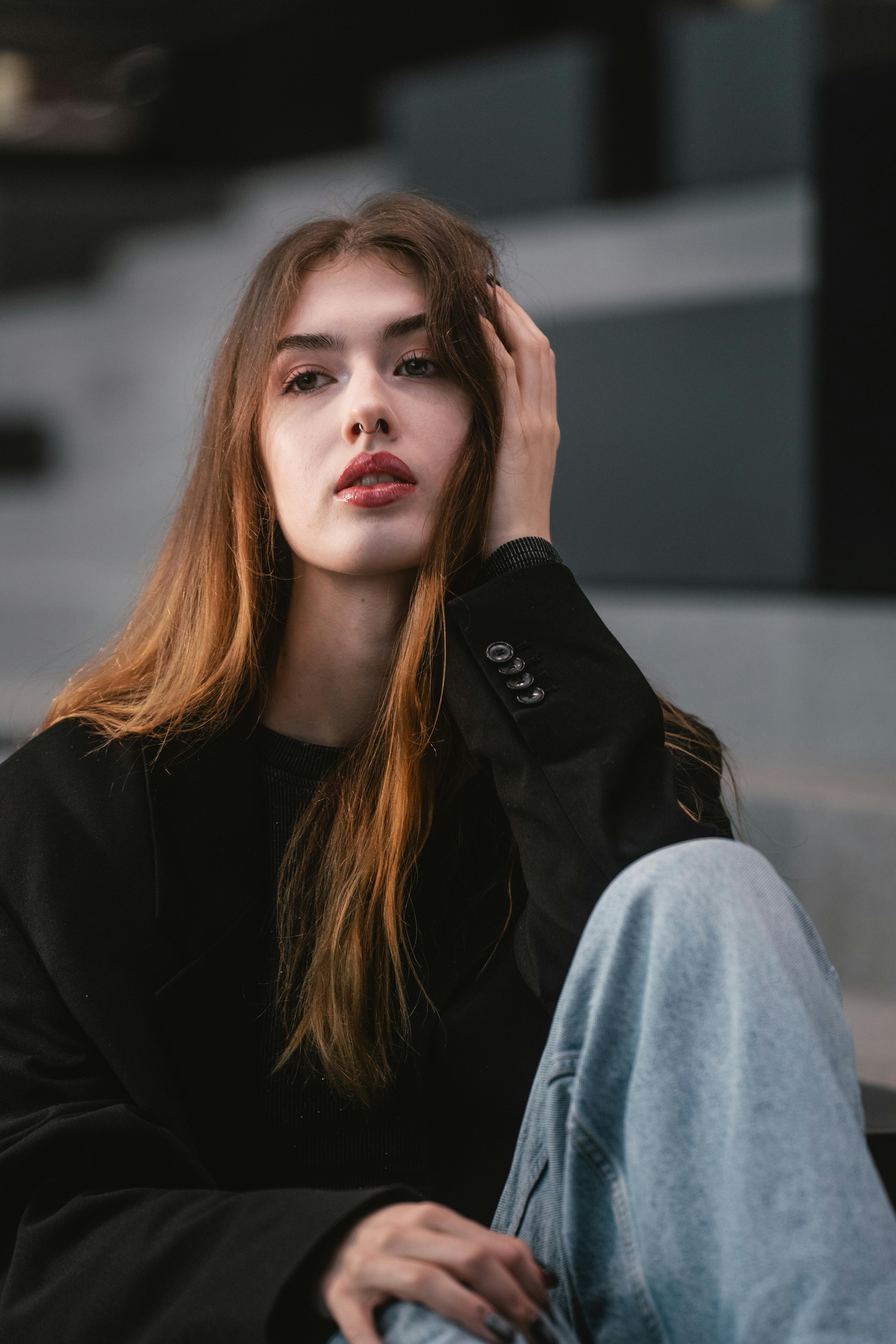 無料 オーストリア、ウィーンの屋外の階段でポーズをとるカジュアルなファッションのスタイリッシュな若い女性。 写真素材