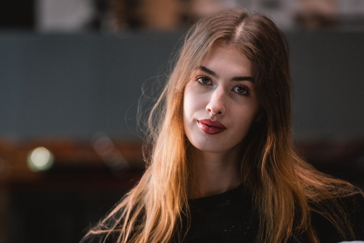 captivating portrait of a young woman with long hair in a cozy vienna