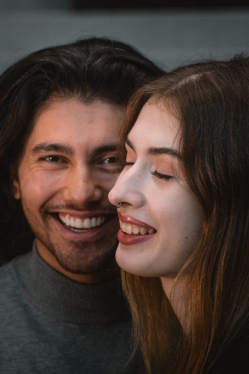 Free Close-up portrait of a happy couple sharing a joyful moment together. Stock Photo