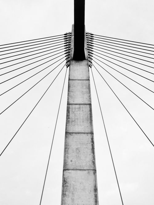 Free Dramatic black and white image of a suspension bridge's structure. Stock Photo