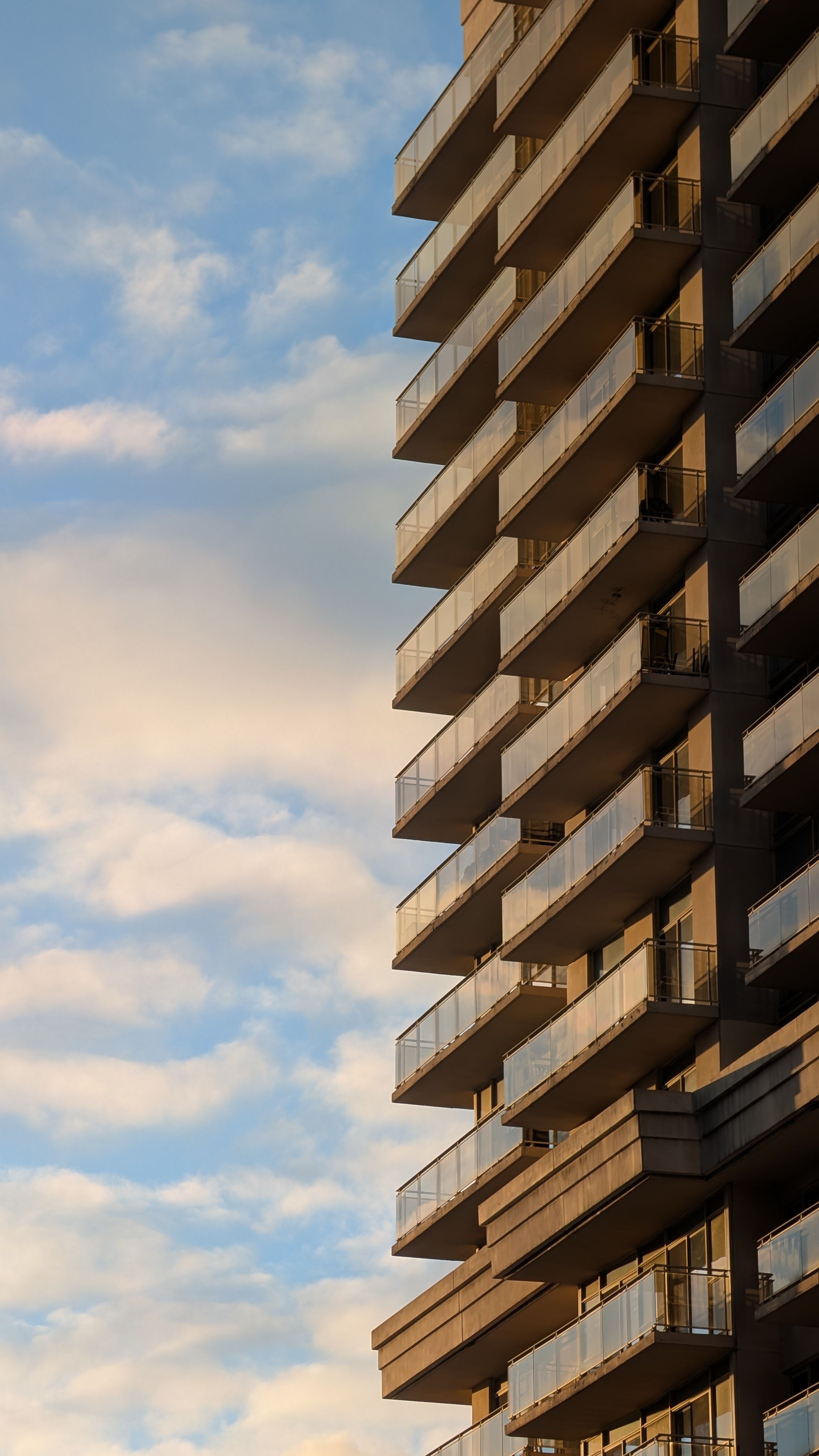 Modern High-Rise Against Blue Sky at Sunset · Free Stock Photo