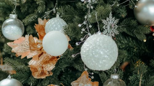 Free Christmas tree with silver and gold decorations, evoking festive elegance. Stock Photo
