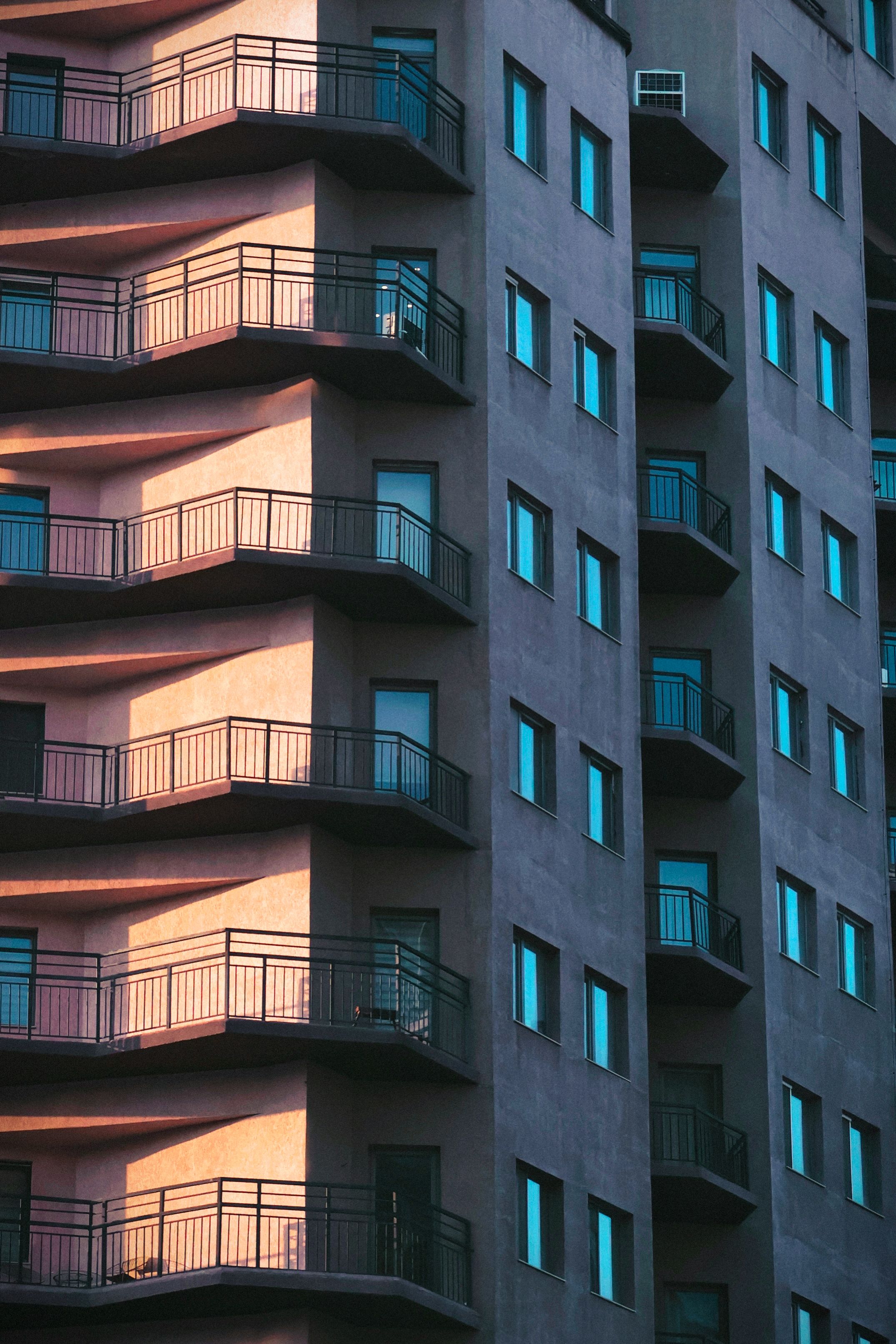 Modern Apartment Building with Balconies at Sunset · Free Stock Photo