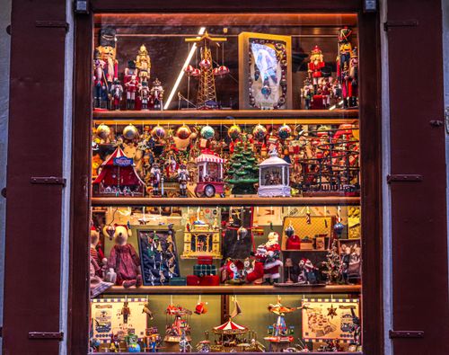 Free Colorful toy shop window decorated with Christmas ornaments, nutcrackers, and festive figurines. Stock Photo