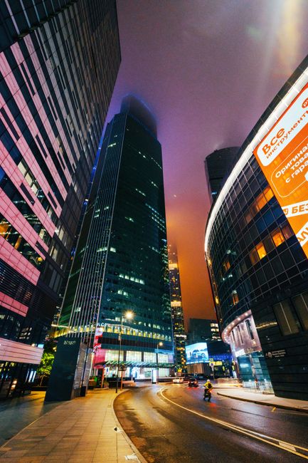 Vibrant nighttime view of modern skyscrapers in Moscow, Russia.
