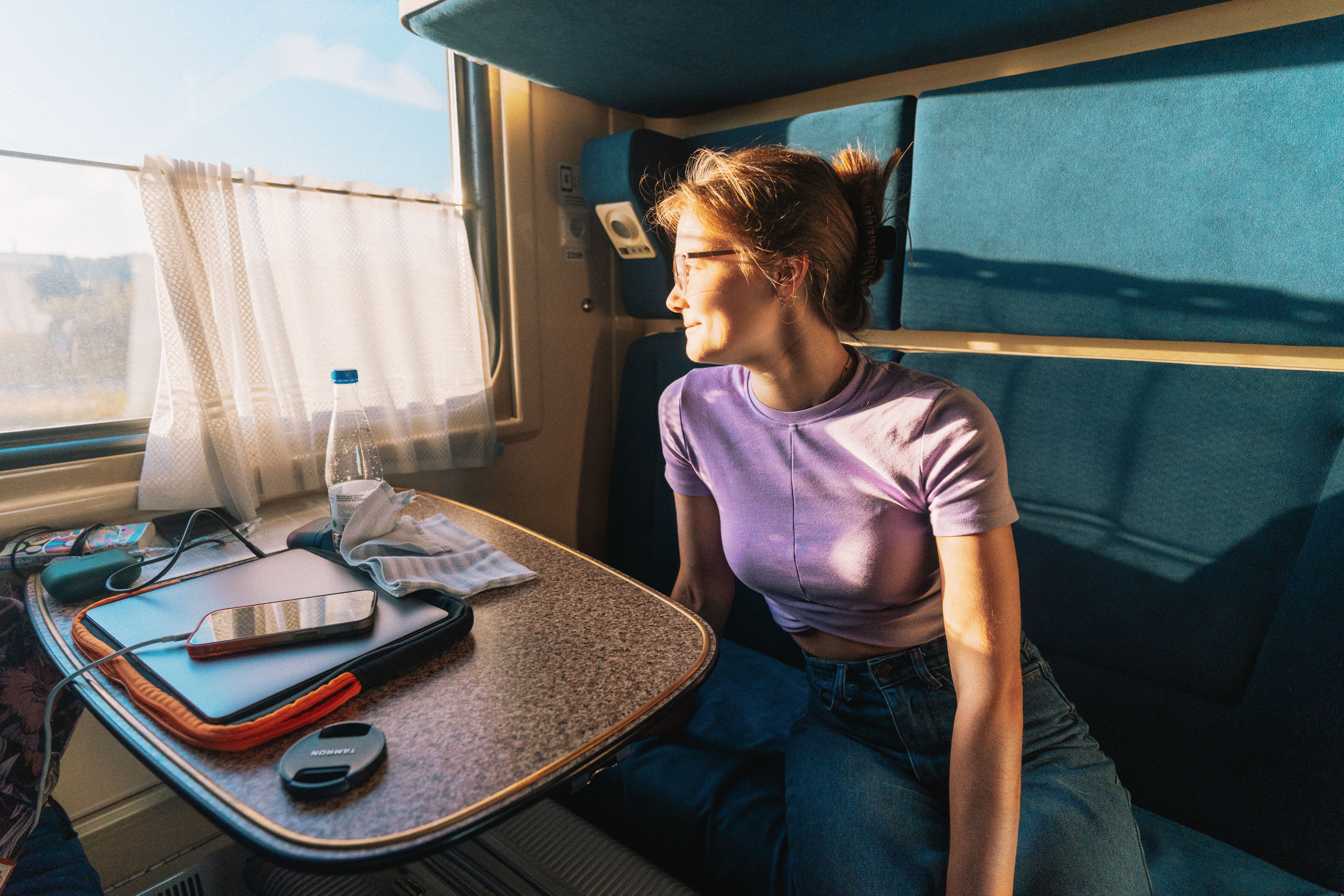 Young Woman Enjoying Scenic Train Journey · Free Stock Photo