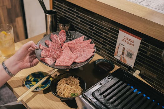 Close-up of premium Wagyu beef slices prepared for a Japanese BBQ experience.