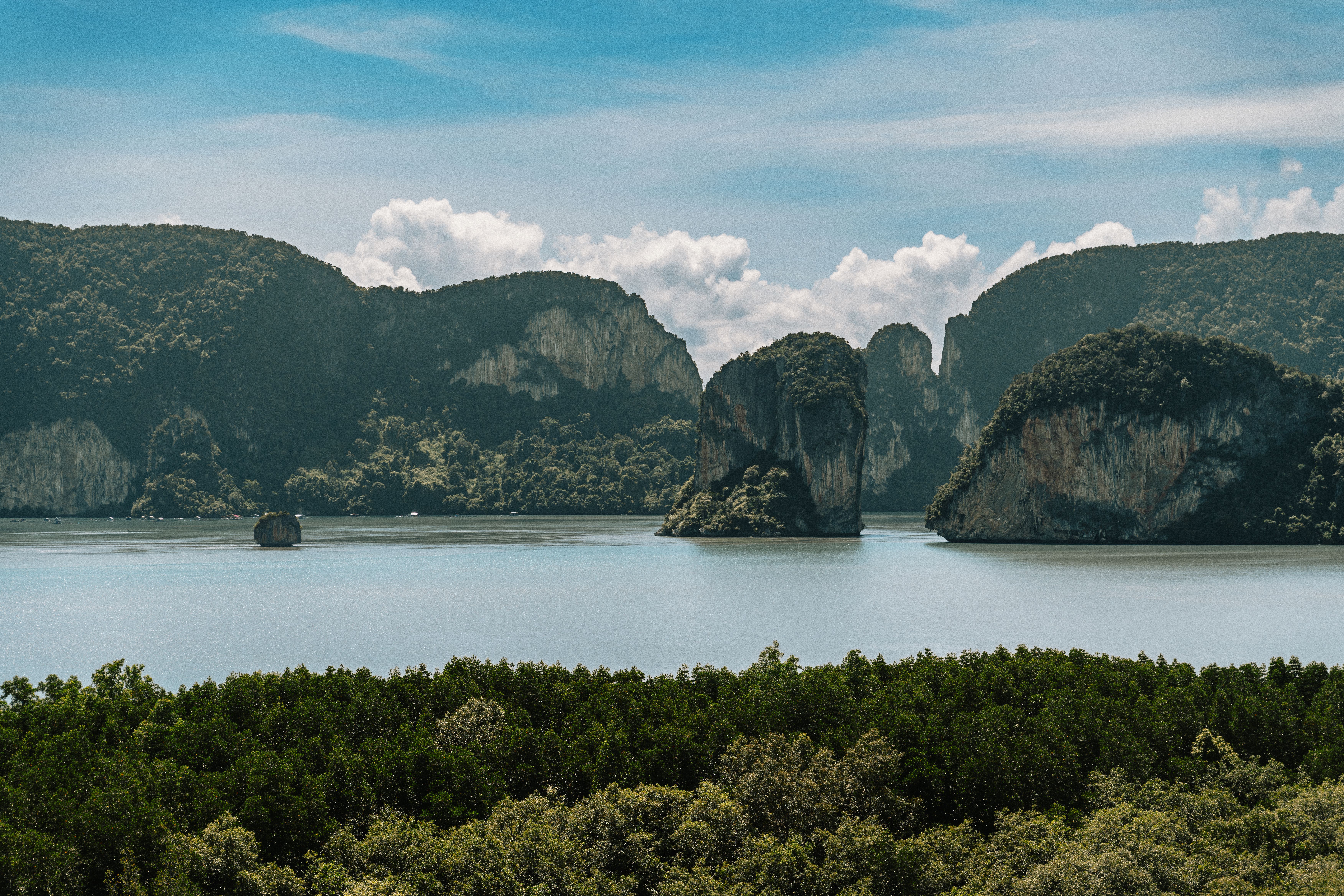 Tranquil view of limestone cliffs and lush greenery in Krabi, Thailand.