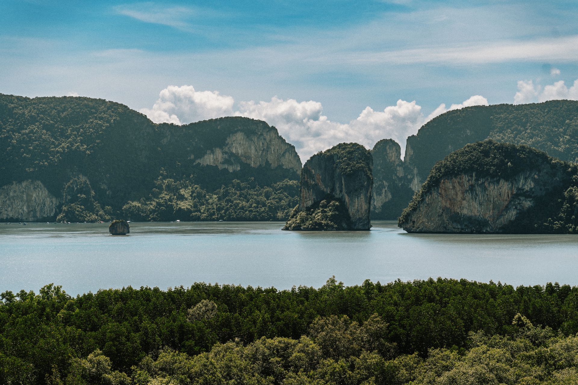 Tranquil view of limestone cliffs and lush greenery in Krabi, Thailand.