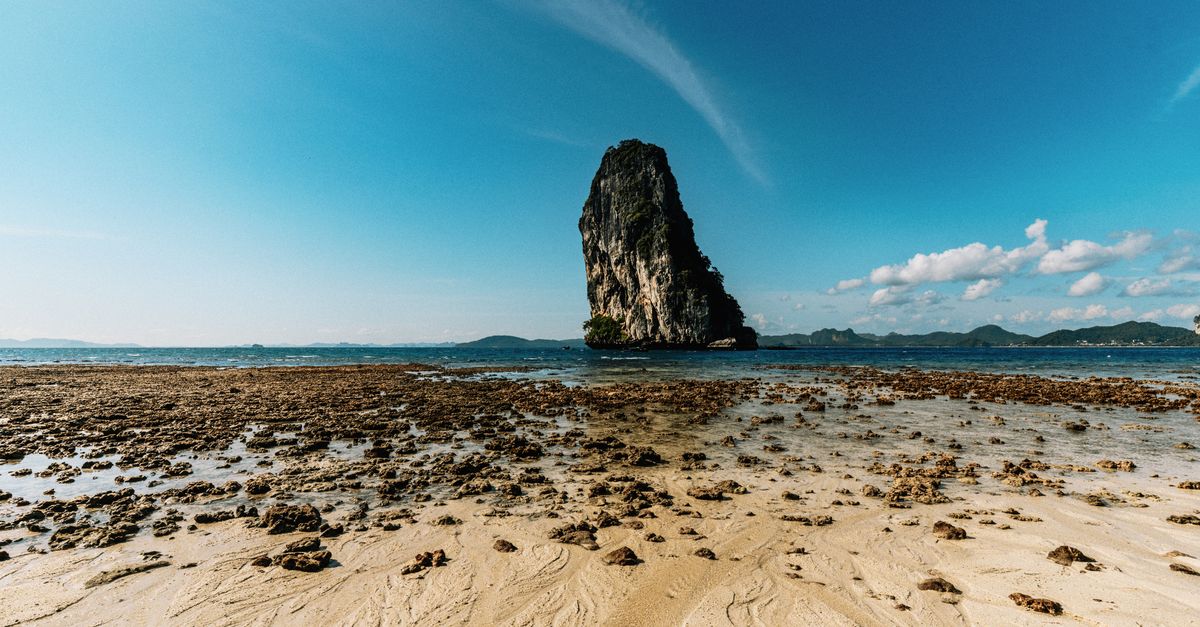 Stunning view of a unique rock formation rising from the sea in Phang Nga, Thailand.
