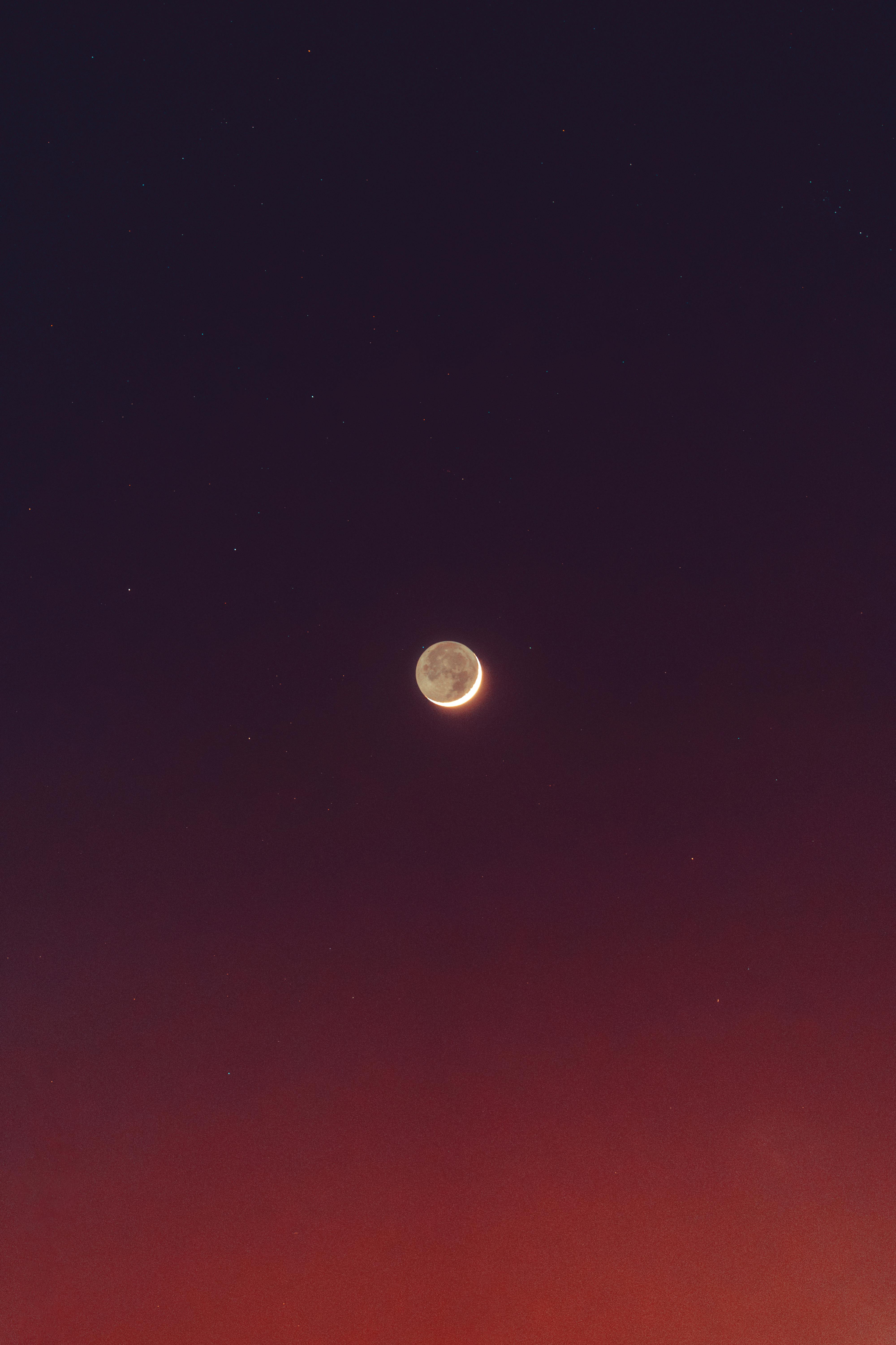 Vibrant twilight sky with a crescent moon above Akumal, Quintana Roo.