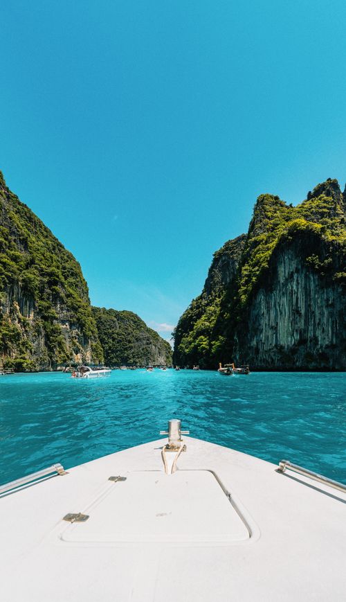 Free Explore breathtaking turquoise waters and lush limestone cliffs on a boat in Krabi, Thailand. Stock Photo