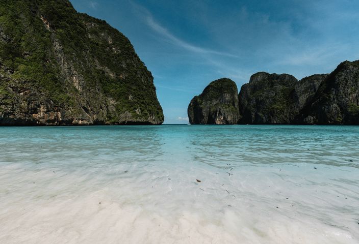 Breathtaking view of Maya Bay's turquoise waters and limestone cliffs in Krabi, Thailand.