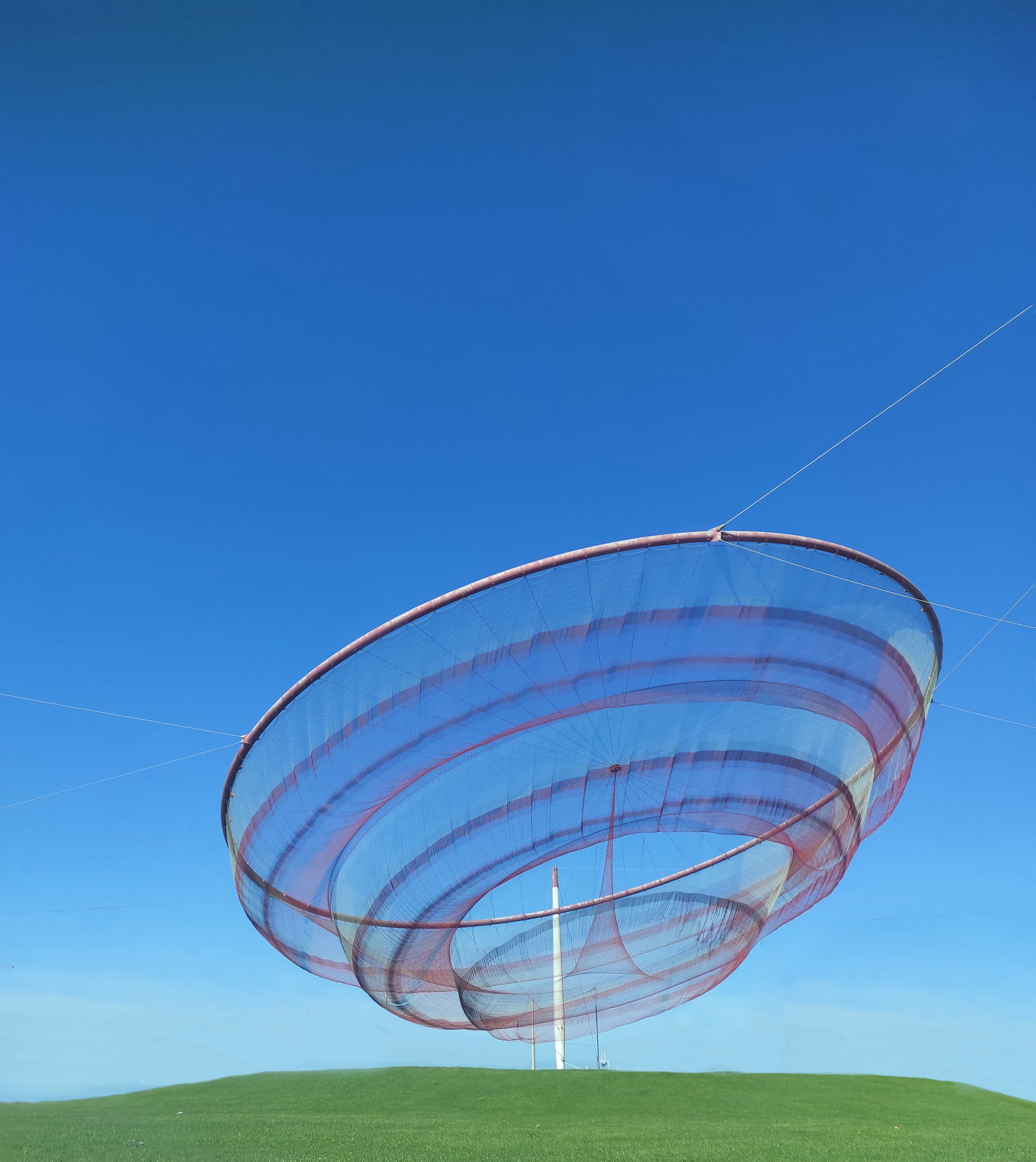Colorful Net Sculpture Against Clear Blue Sky · Free Stock Photo