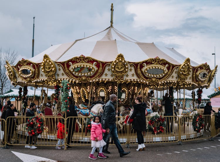 People Around Carousel In Amusement Park