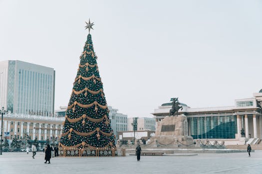 Holiday decorations in Ulaanbaatar's central square featuring a large Christmas tree and Chinggis Khaan statue.
