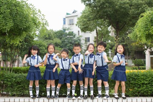 Free Joyful group of children in school uniforms posing outdoors, symbolizing friendship and education. Stock Photo