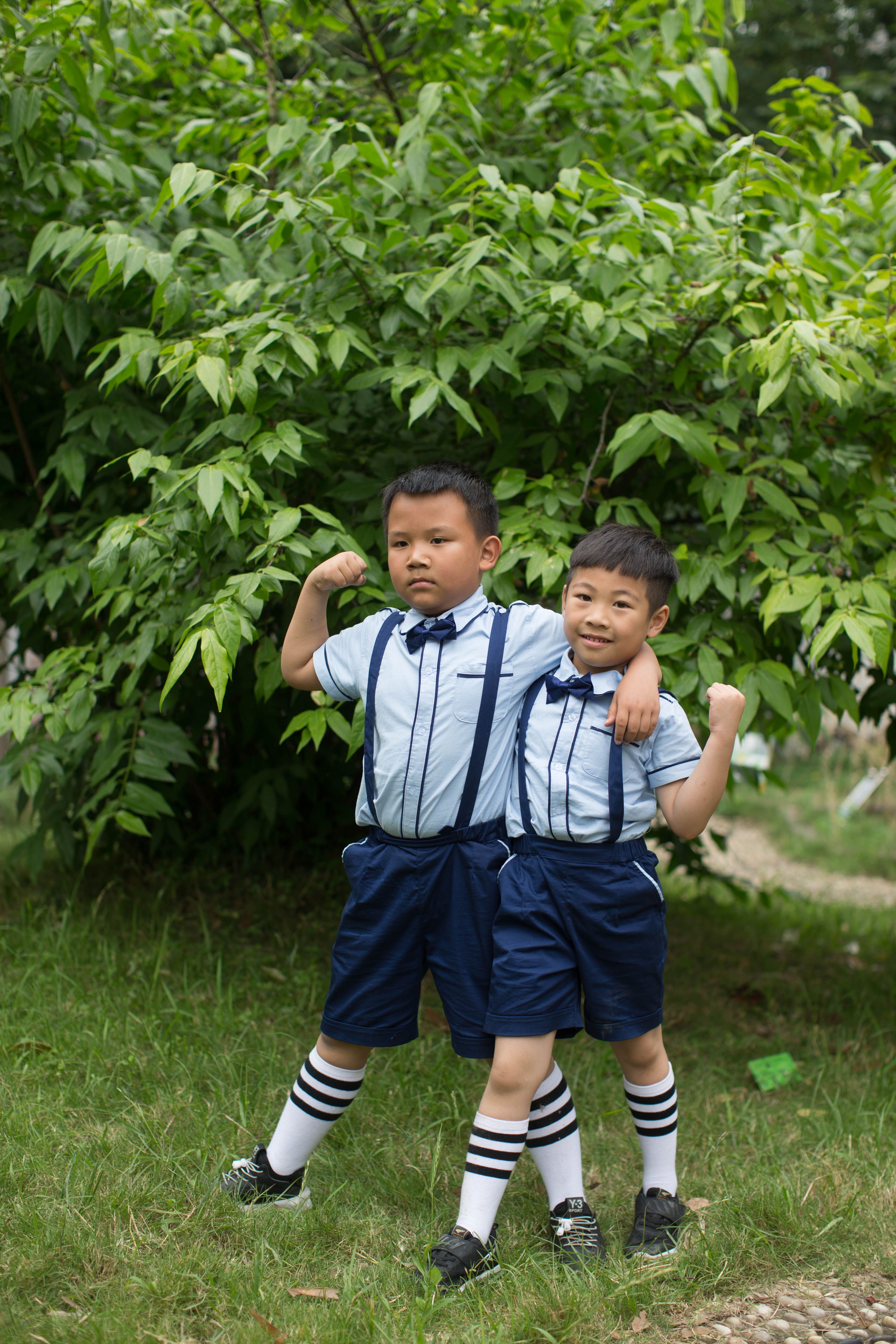 Two children in colorful casual outfits outdoors